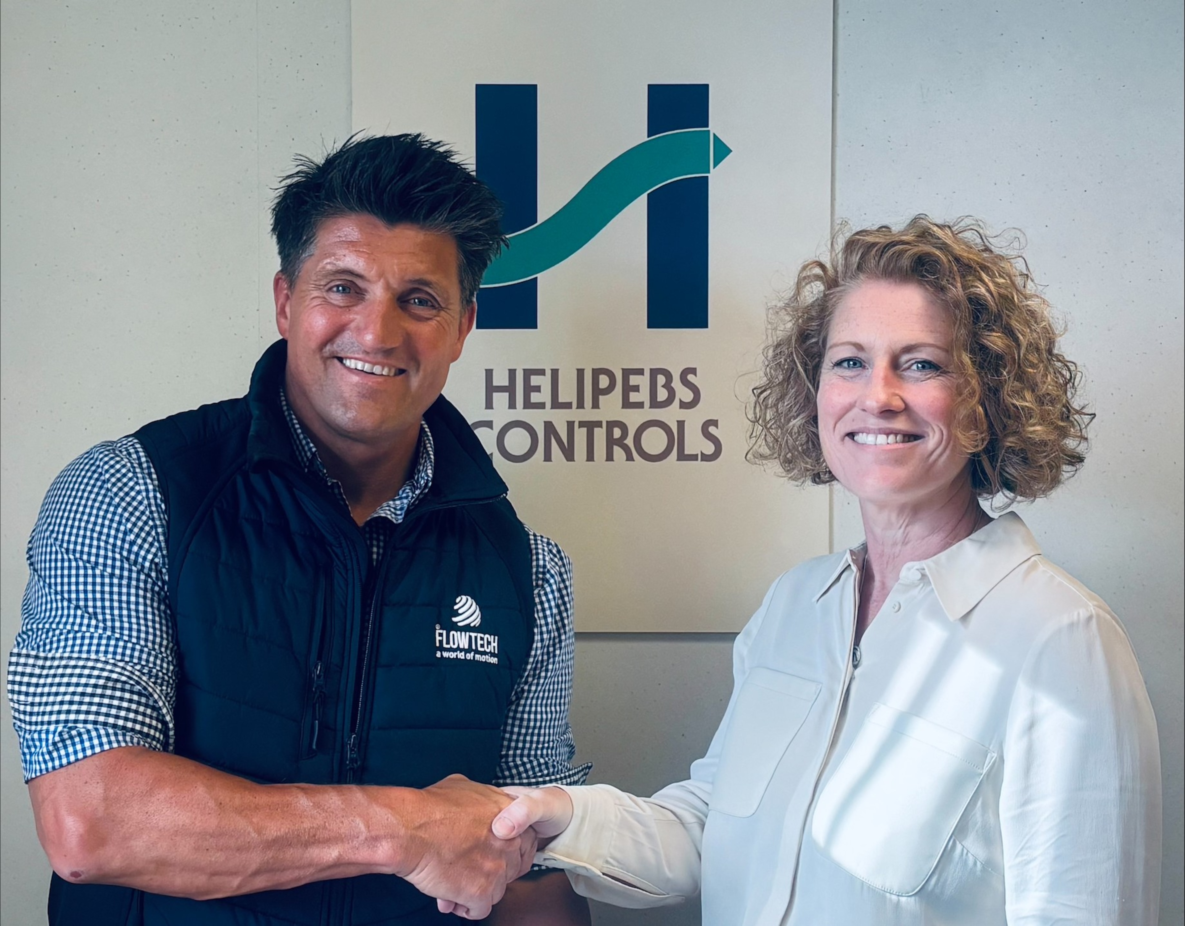 Mike England shaking hands with Helpibs Controls Ltd managing director Victoria Hayward