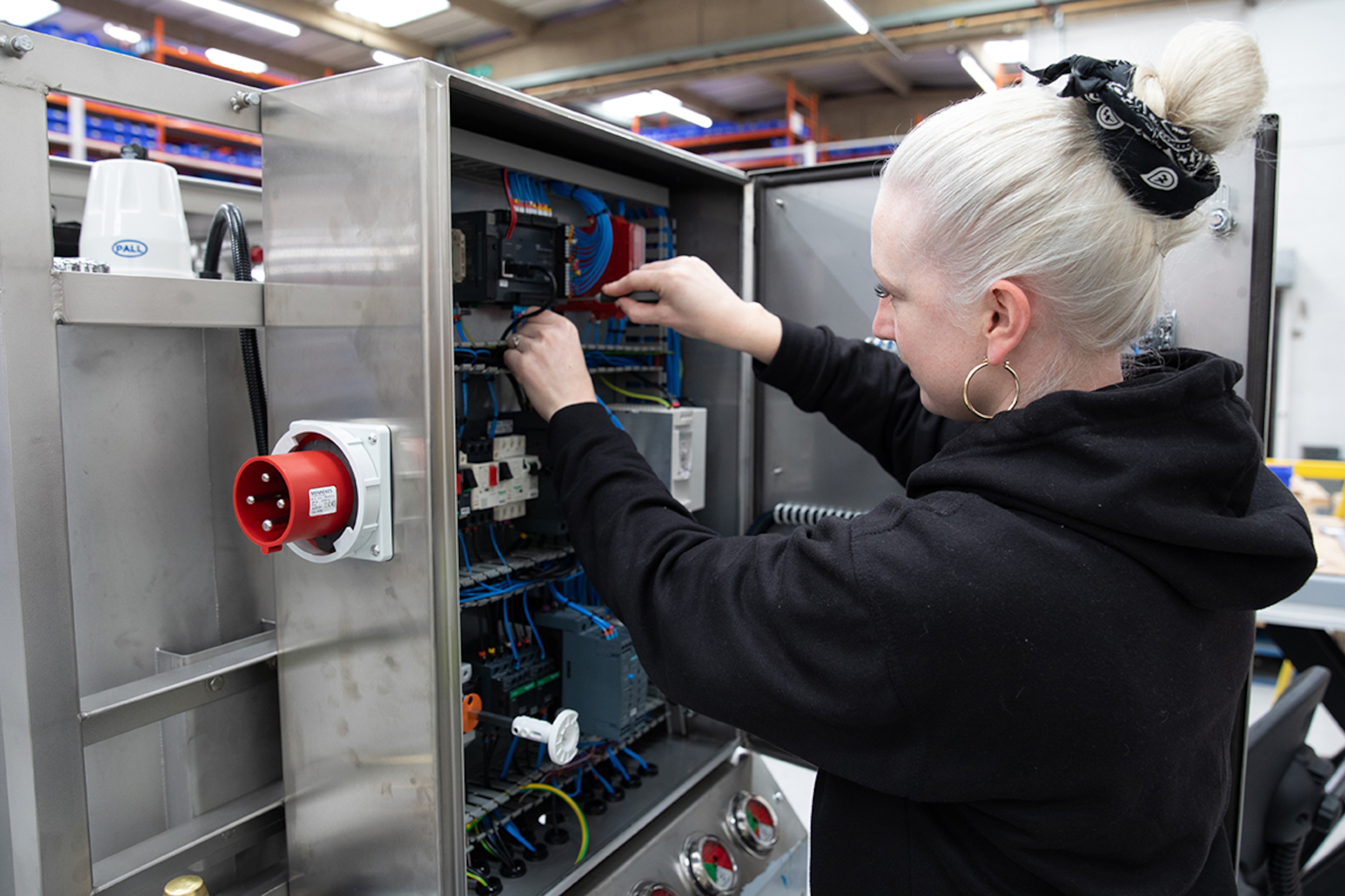 Female engineer working on a control panel